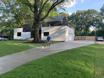 team cleaning a driveway